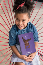 Load image into Gallery viewer, Child holding a book titled 'Mama &amp; Me' with a purple cover and brown character, sitting on a red and gray chair.
